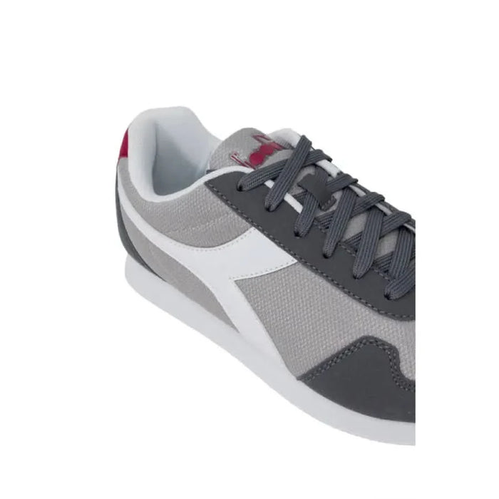 Athletic sneaker featuring gray, white, dark gray color blocks, and pink accents by Diadora