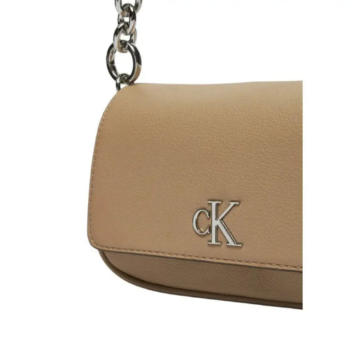 Beige Calvin Klein handbag featuring silver CK logo and chain strap for women