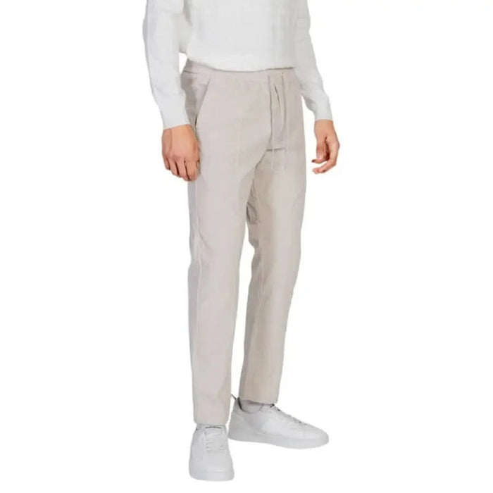 Beige Antony Morato men trousers styled with white sneakers and a white top