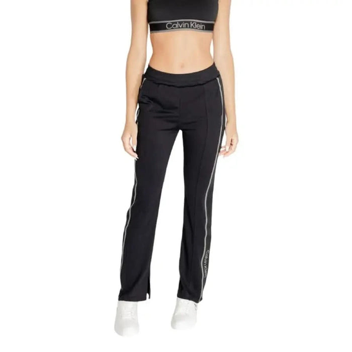 Black athletic pants with white stripes and Calvin Klein waistband for women