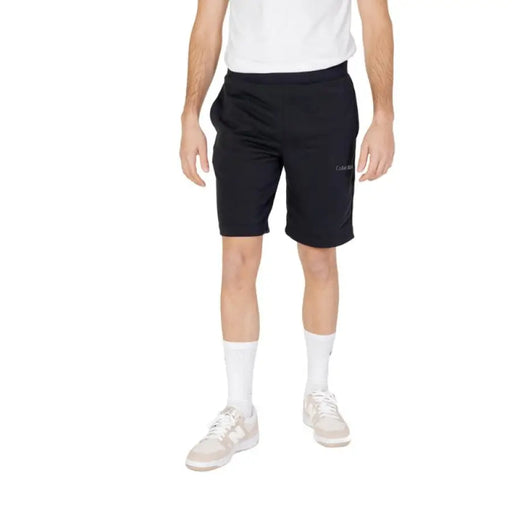 Calvin Klein Sport Men Shorts Black athletic shorts worn by person in white shirt and socks