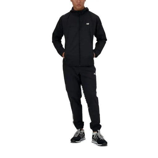 Black athletic tracksuit with zip-up jacket and matching pants by New Balance