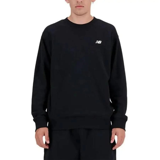 Black New Balance crewneck sweatshirt worn by a person from New Balance Men Sweatshirts