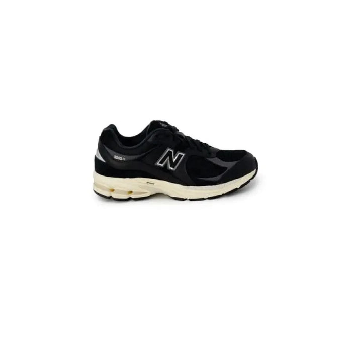 Black New Balance running shoe with white sole from New Balance Men Sneakers collection