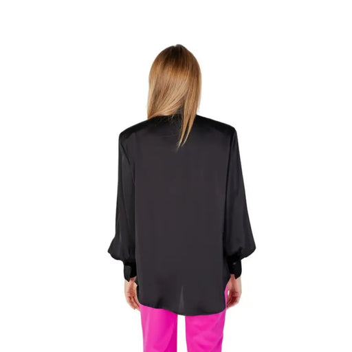 Black blazer over bright pink pants, view from behind, showcasing Silence Women Shirt