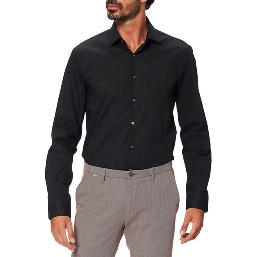 Calvin Klein black button-up dress shirt paired with gray trousers