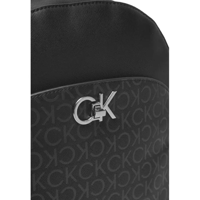 Black Calvin Klein bag featuring monogram pattern and metallic CK logo, ideal for women