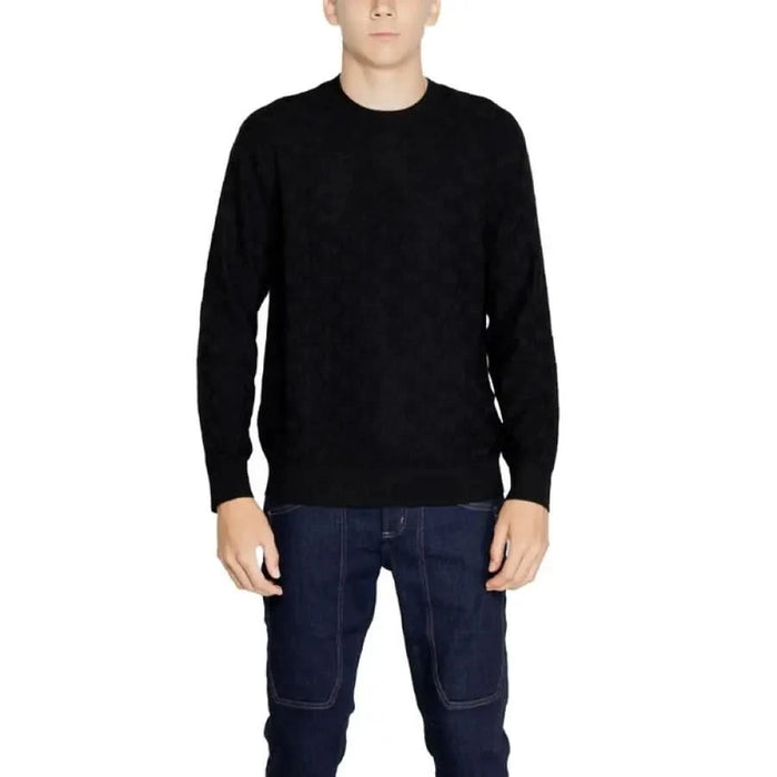 Black crew neck sweater worn by a model from Armani Exchange Men Knitwear collection