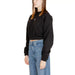 Calvin Klein black cropped sweatshirt paired with blue jeans for women