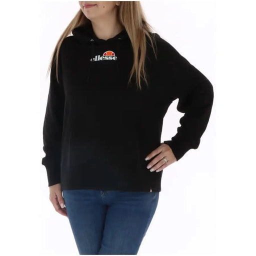 Ellesse Women Sweatshirts: Black Ellesse hoodie worn by person with long blonde hair, blue jeans