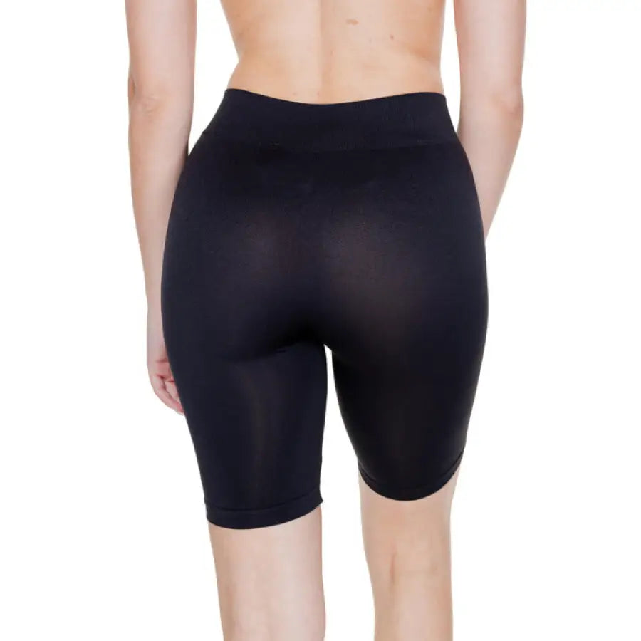 Vero Moda Women’s black form-fitting exercise shorts displayed on a person’s lower body