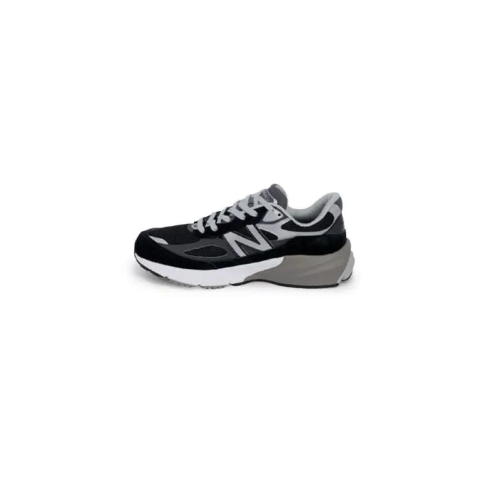 Black and gray New Balance athletic sneaker with a white sole for men