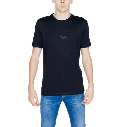 Guess Men T-Shirt in Black worn by model with Blue Jeans