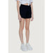 Black high-waisted shorts with a cropped white top and white sneakers - Guess Women Short