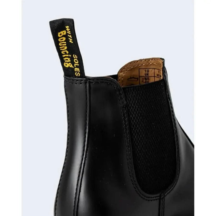 Black leather Chelsea boot with elastic side panels and pull tab by Dr. Martens