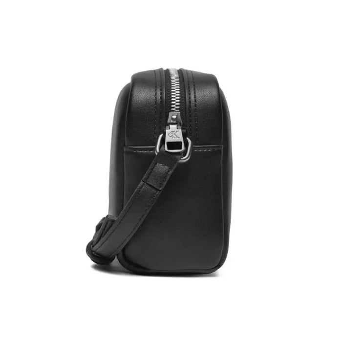 Black leather crossbody bag with silver zipper closure by Calvin Klein