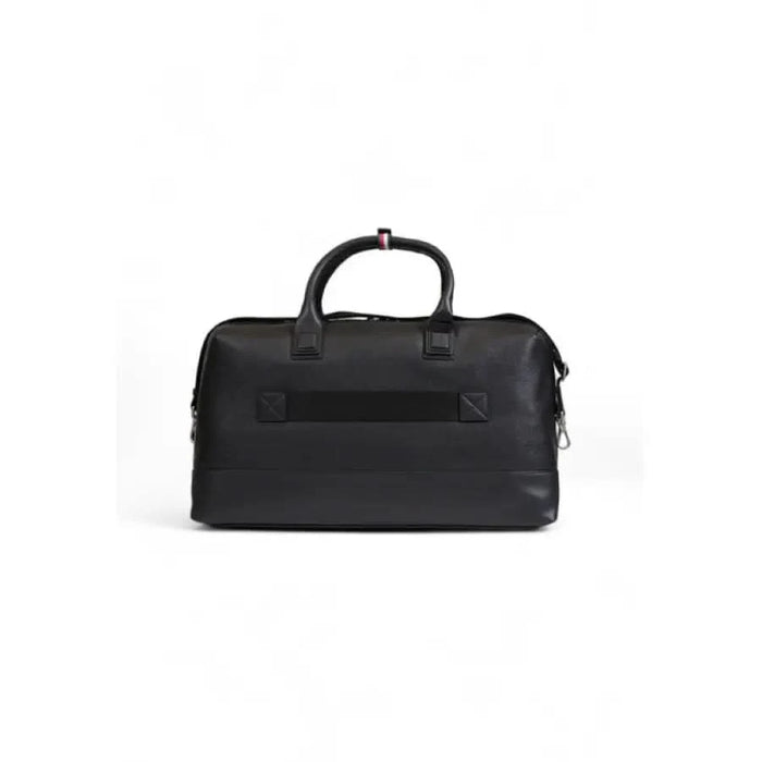 Black leather duffel bag with handles and zipper closure by Tommy Hilfiger