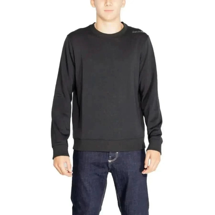 Black long-sleeved crewneck sweater worn by a model from Calvin Klein Sport collection