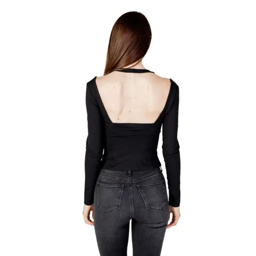 Calvin Klein Women T-Shirt: Black Long-Sleeved Open Back Top Paired with Dark Jeans