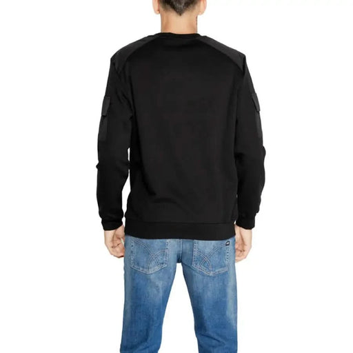 Model wearing Antony Morato black long-sleeved sweatshirt with blue jeans, back view