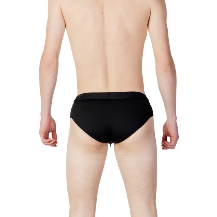 Model wearing Calvin Klein Jeans Men’s black briefs from behind