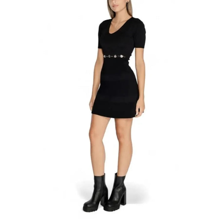 Black short-sleeved mini dress with belted waist and scoop neckline by Morgan De Toi