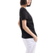 Black short-sleeved t-shirt paired with white pants from Armani Exchange Women’s collection