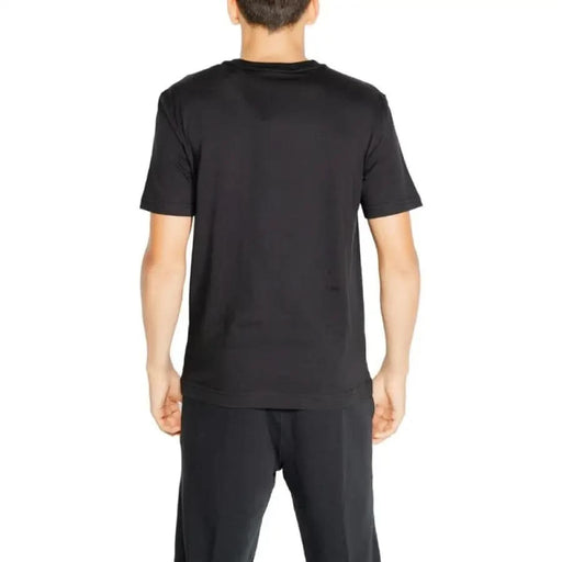 Black short-sleeved Calvin Klein Sport T-Shirt worn by a person from behind