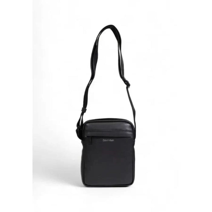 Black shoulder bag with single strap and zippered compartment by Calvin Klein Men