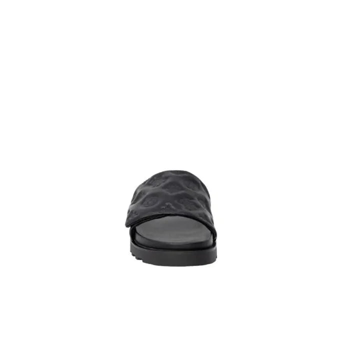 Black slide sandal with a textured strap and flat sole from Guess Women Slippers