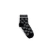 Black sock featuring white circular logo and GUESS branding for Women Underwear