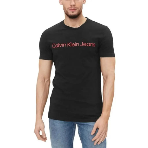 Black Calvin Klein Jeans Men T-Shirt featuring red text across the chest