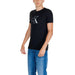 Black Calvin Klein T-shirt with CK logo worn by person in blue jeans