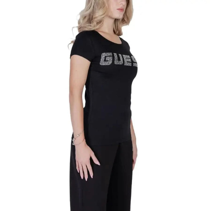 Black T-shirt dress featuring sparkly GUESS text across the chest for women