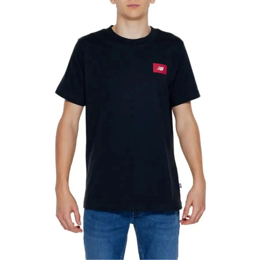 Black T-shirt with small red New Balance logo on chest in New Balance Men T-Shirt collection