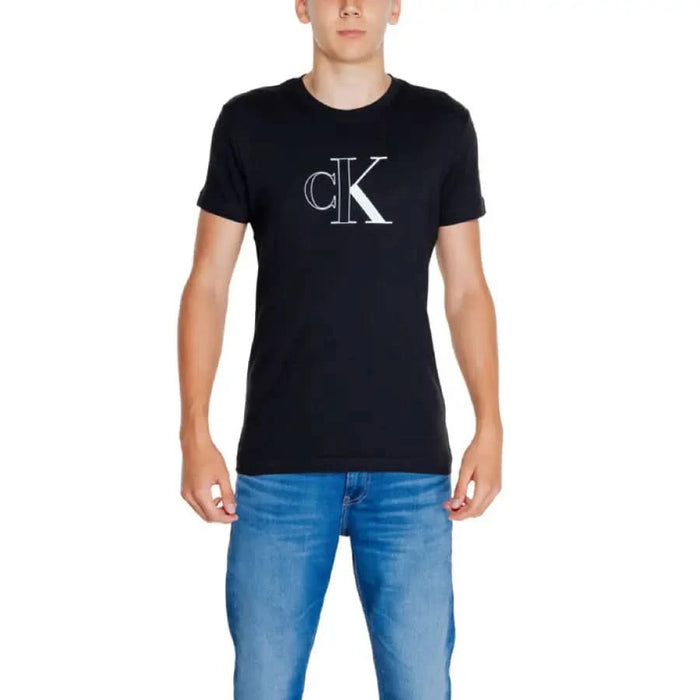 Calvin Klein Jeans Men T-Shirt Black with White CK Logo worn by person in Blue Jeans