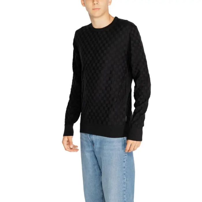 Black textured crewneck sweater worn with jeans from Calvin Klein Men Knitwear