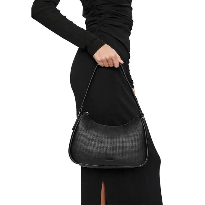 Black textured leather shoulder bag with curved shape and single strap by Calvin Klein Jeans