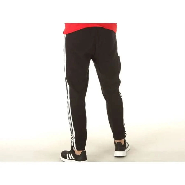 Adidas Men Trousers featuring black track pants with white side stripes and a red waistband