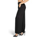 Black wide-leg dress pants with pockets paired with stiletto heels by Rinascimento