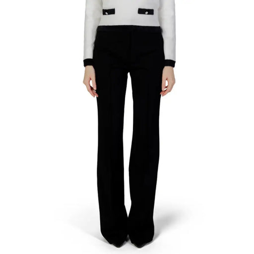 Black wide-leg trousers with a white and black long-sleeved top from Morgan De Toi