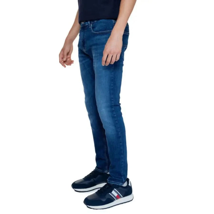 Blue denim jeans on a person, showcasing Tommy Hilfiger Men’s Jeans style