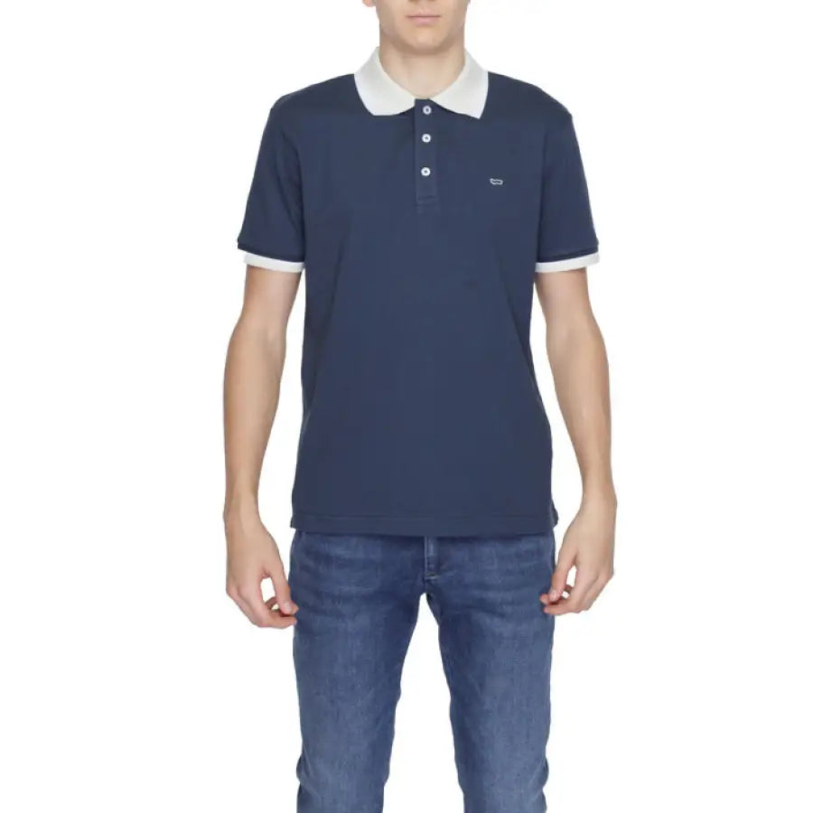 A boy wearing a navy polo shirt from the Gas - Gas Men Polo collection