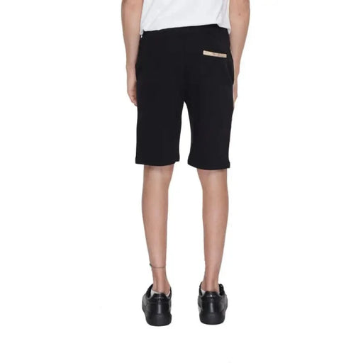 A boy in a white T-shirt and Alviero Martini Prima Classe Men Shorts in black