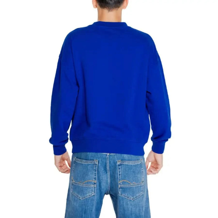 Bright blue crewneck sweatshirt from Replay Men Sweatshirts, back view on person facing away