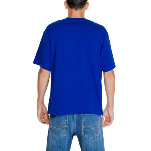 Bright blue short-sleeved Replay Men T-Shirt modeled by person facing backward