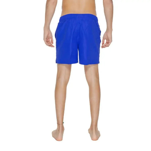 Bright blue Nike Swim Men Swimwear board shorts modeled by a wearer