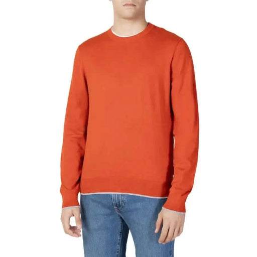 Bright orange long-sleeved crewneck sweater worn by model from Armani Exchange Men Knitwear