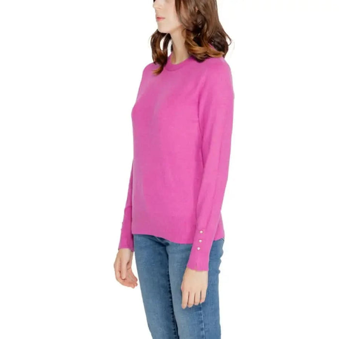 Bright pink long-sleeved sweater worn by a woman with blue jeans from Jacqueline De Yong