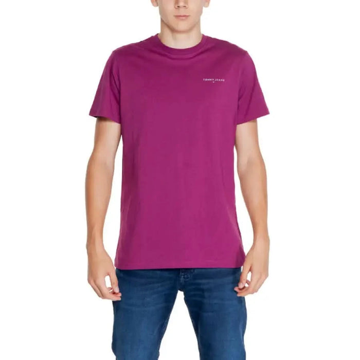 Bright purple Tommy Jeans t-shirt worn by a person in blue jeans.